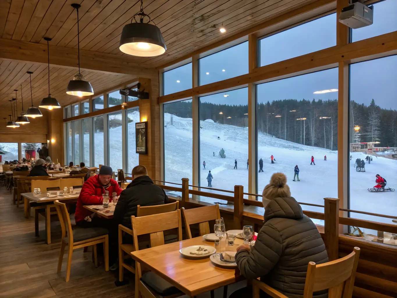 A cozy and inviting restaurant at Warmwell Snowsports Centre, with skiers and snowboarders enjoying a warm meal and drinks.